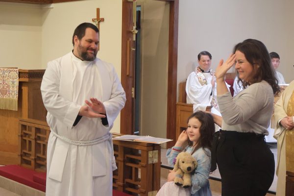 Jon Galles and family standing in front of the congregation