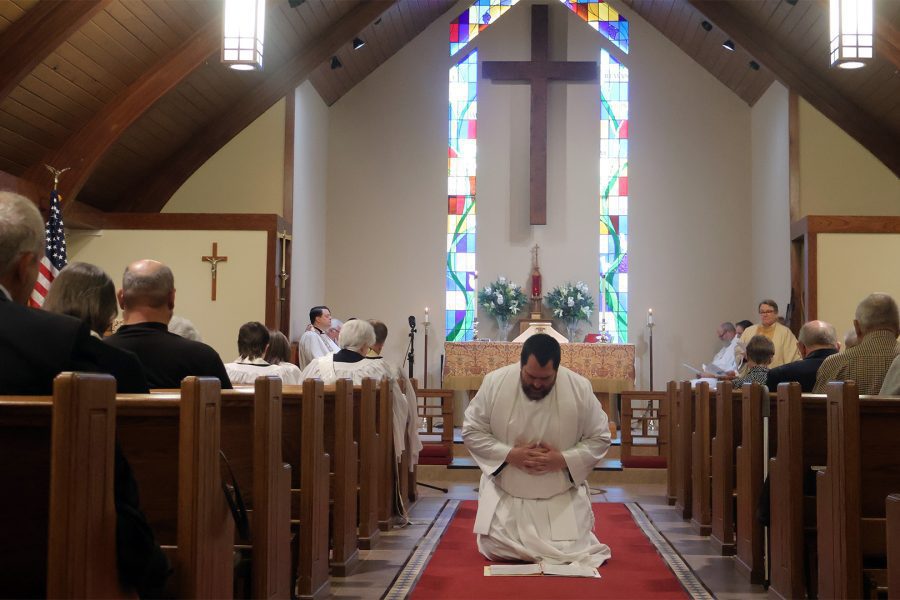 Jon Galles kneeling in aisle x