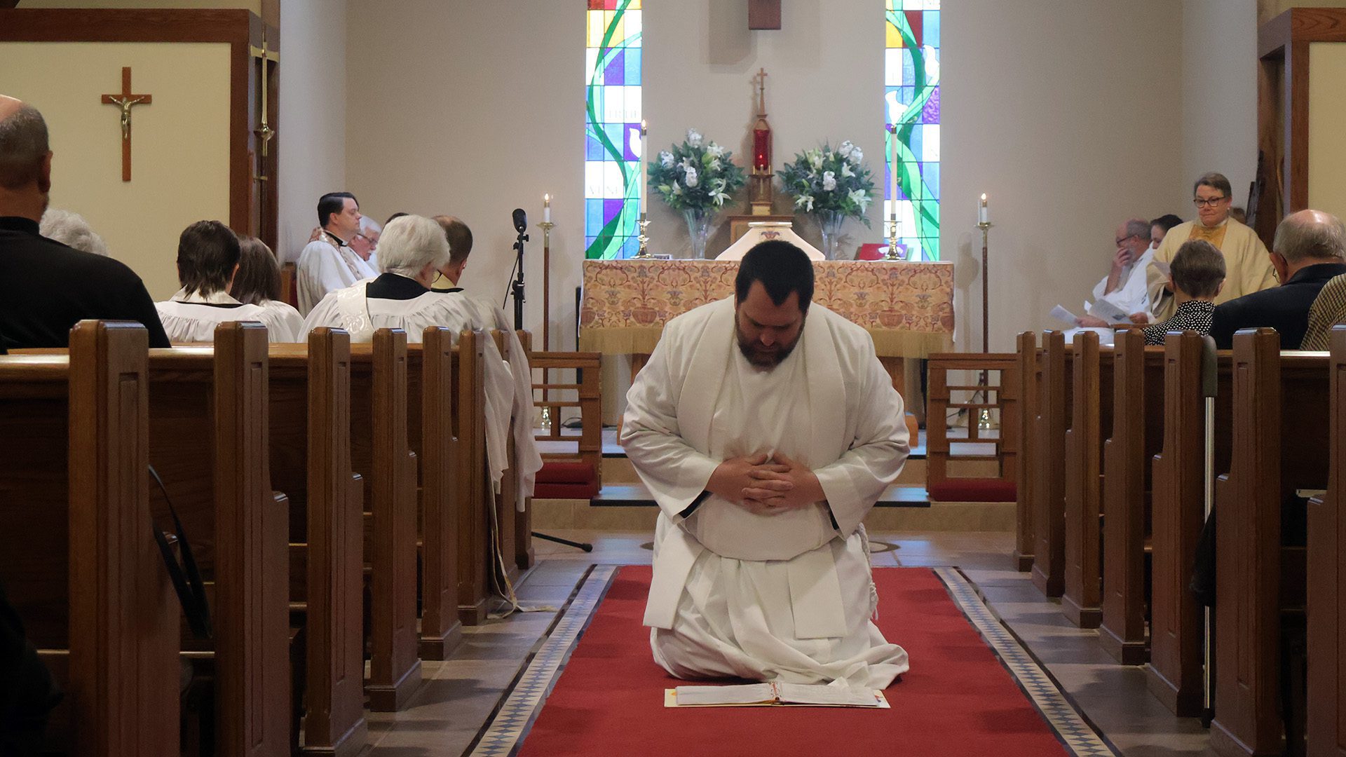 Jon Galles kneeling in aisle