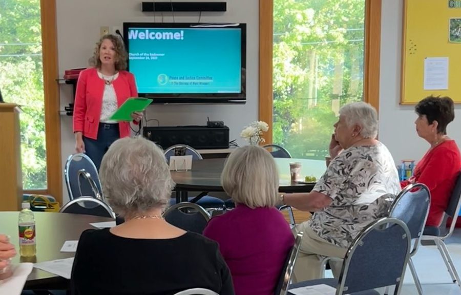 Tara Bennett speaking to a crowd during a Be SMART Presentation