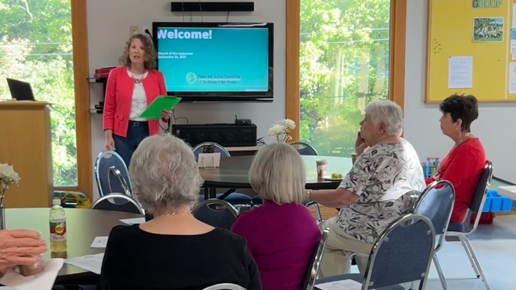 Tara Bennett speaking to a crowd during a Be SMART Presentation