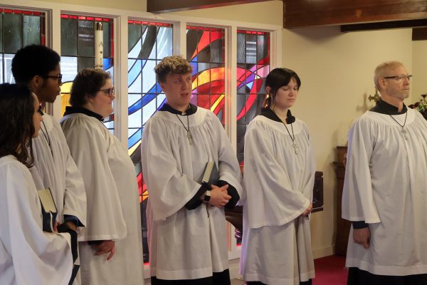 the choir standing at the back of the church