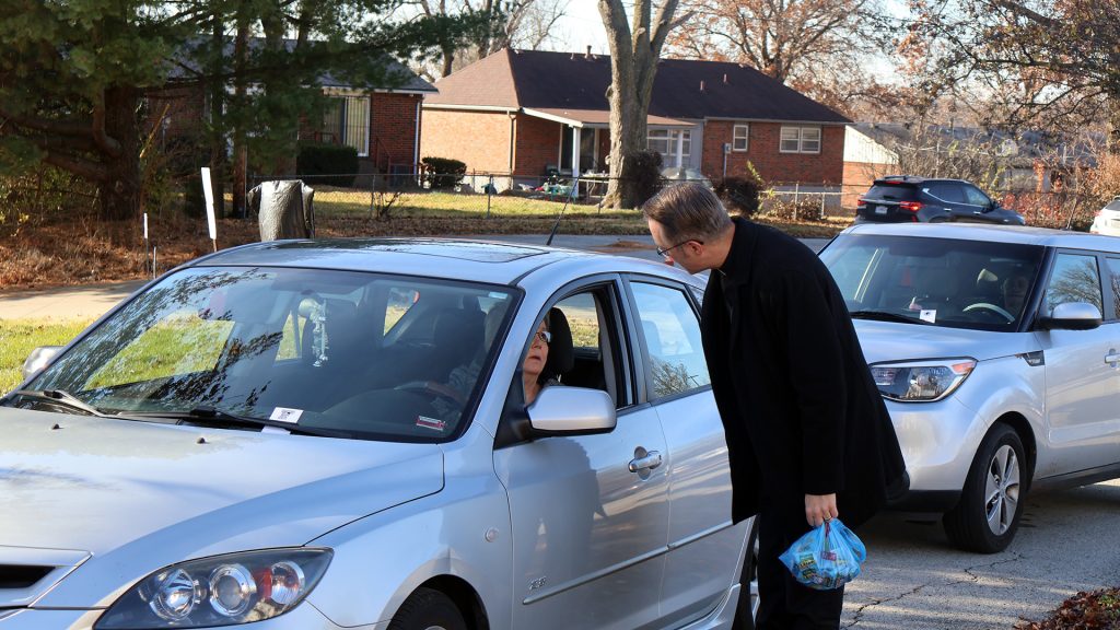 Fr. Ryan greeting a person