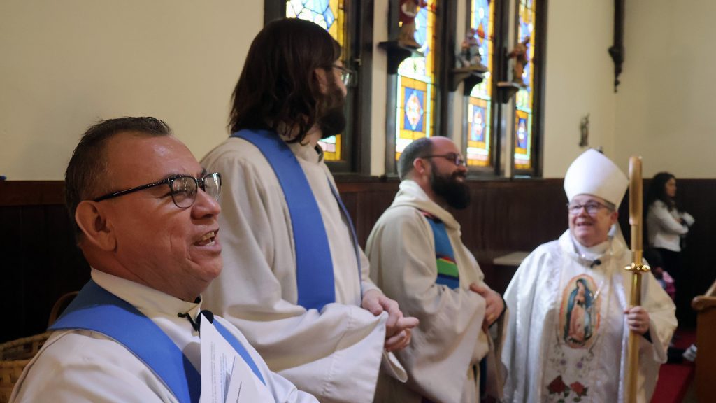 priests and bishop singing
