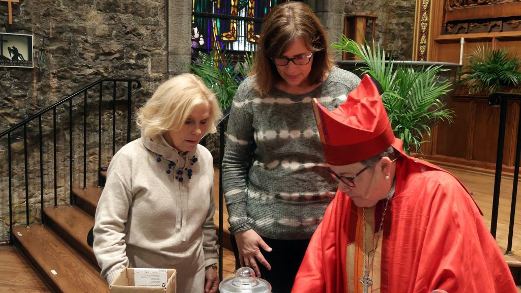 Bishop Bruce and volunteers for filling oil