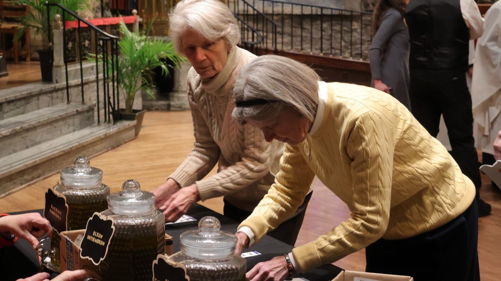 Volunteers filling bottles with oil