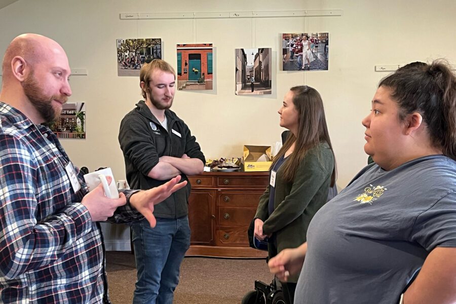 Two young adults talking during a workshop at retreat cropped